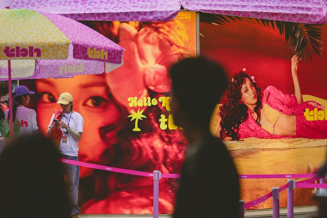 fans taking selfie with celebrity poster